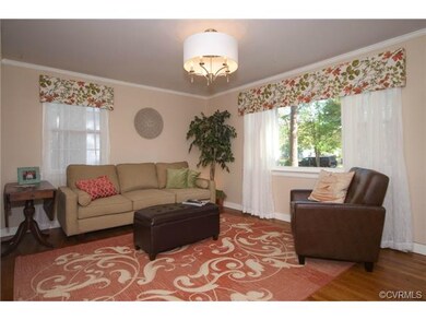 The living room has hardwood floors, a picture win