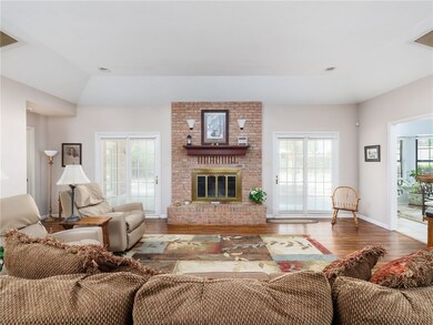 Living room with lofted ceiling, wood-type floorin