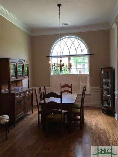Dining room with hardwood floors. Wainscoting and 