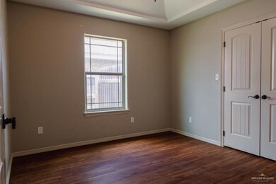Empty room with dark hardwood / wood-style flooring