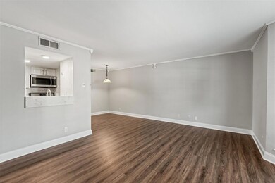 Unfurnished living room featuring crown molding, 