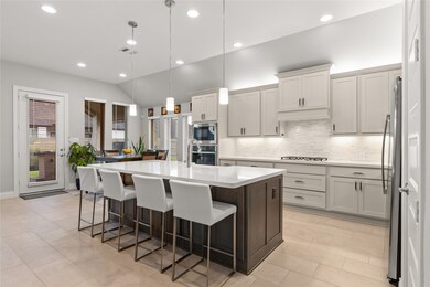 This kitchen is by far any chef’s dream! This spacious kitchen features large windows, high ceilings, white stained wood cabinets, quartz countertops, SS appliances, modern tile backsplash, recessed lighting with additional custom pendant lighting, extended counter space, quartz kitchen island with large sink and space for a breakfast bar, and a walk-in pantry all overlooking your huge family room.