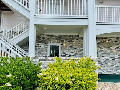 Entrance to property featuring brick siding