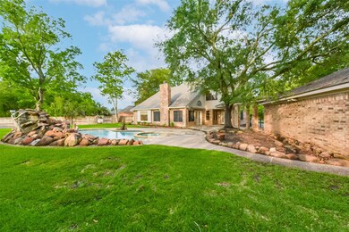 This beautifully landscaped backyard features a sp