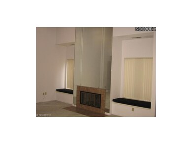 TILED FOYER AND FIREPLACE SUROOUND. MIRRORED BACK 