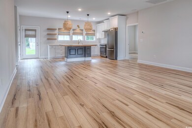 Unfurnished living room with sink and light hardwo
