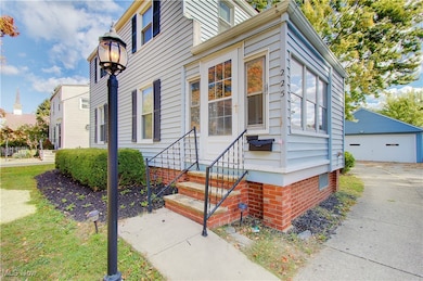 Property entrance with a detached garage and crawl space