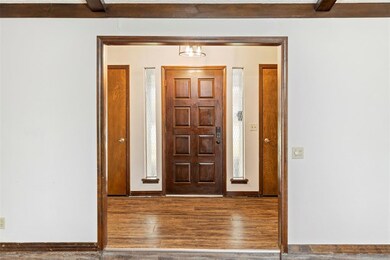Entrance foyer with baseboards and wood finished f