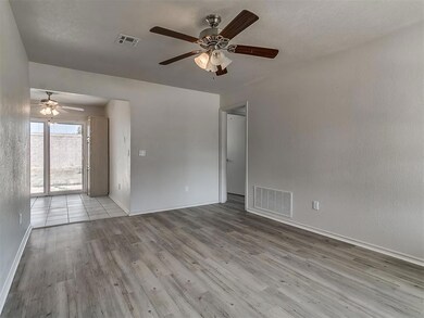 Empty room with ceiling fan and wood-type flooring