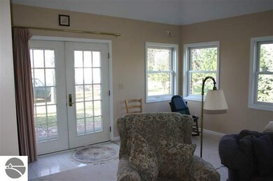 Large sun room/family room with a gas fireplace and 1/2 bath, French doors to deck.