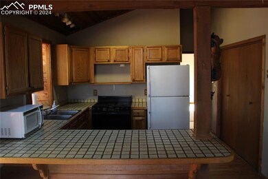 Kitchen featuring lofted ceiling with beams, kitch