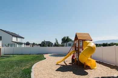 View of playground with a fenced backyard and a residential view