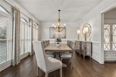 Dining space with wainscoting, ornamental molding,