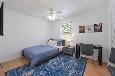 Bedroom featuring light wood finished floors and a ceiling fan