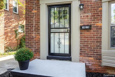Property entrance featuring brick siding