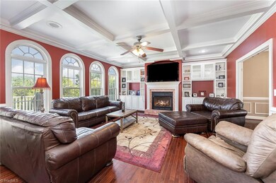 The spacious Great Room features coffered ceilings; Built in Shelving/Bookcases; hardwood flooring and Gas Fireplace.