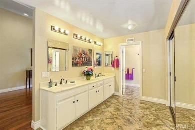 Bathroom with tile floor, double closet, step down