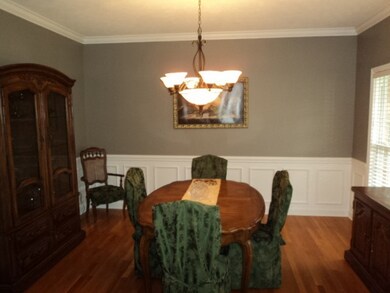 Dining room featuring wainsoting and wood floors
