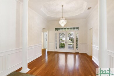 Foyer with trey ceiling and wainscoting