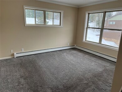 Carpeted empty room with ornamental molding and a
