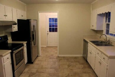Large open kitchen with NEW appliances and New porcelain tile