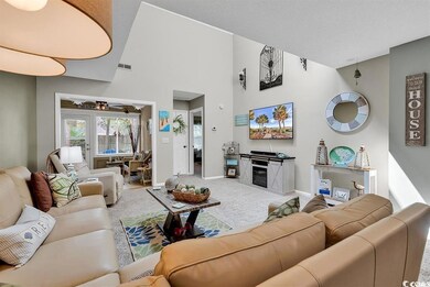 Living room with carpet, baseboards, a high ceilin