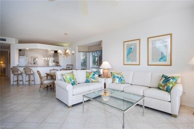 Tiled living room featuring an inviting chandelier