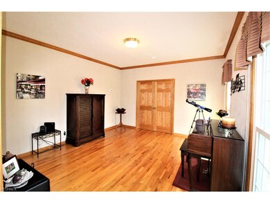Living Room with Hardwood Floor and Crown Molding