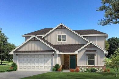 View of front of home with a garage and a front la