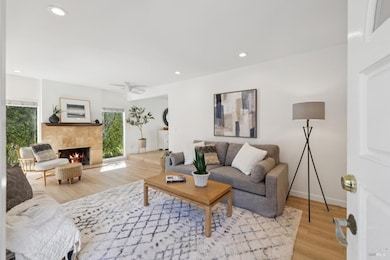 Large cozy living room with access and view to the private courtyard.  Wood fireplace.