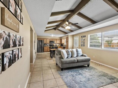 Living room featuring light tile flooring, lofted 