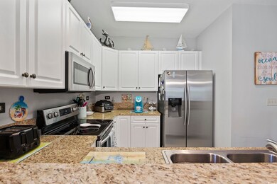 Kitchen with light stone counters, stainless steel