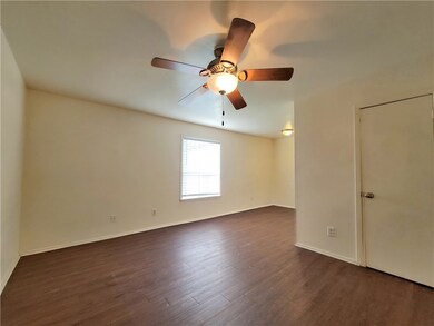 Empty room featuring dark wood-style flooring, bas