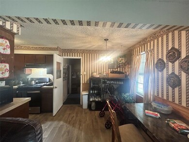 Dining area with wood-type flooring and a textured