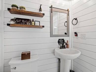Bathroom featuring wooden walls and toilet
