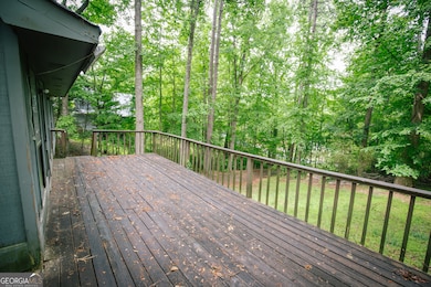 The home features a large deck perfect for a family gathering to look at the lake or down the large front lot.