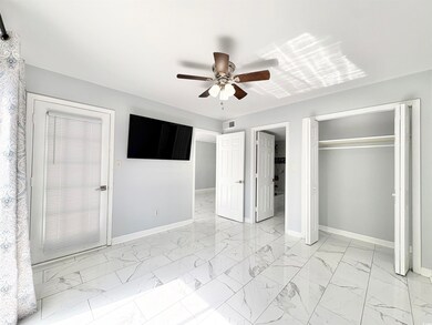 Unfurnished bedroom with marble finish floor, base