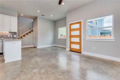 Unfurnished living room featuring concrete floori