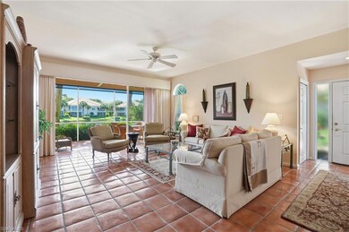 Living room with tile patterned floors and a ceiling fan