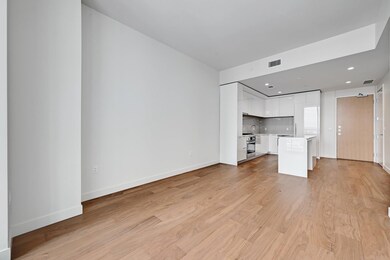 Unfurnished living room featuring baseboards, vis