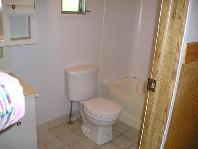Full bath with tile floor