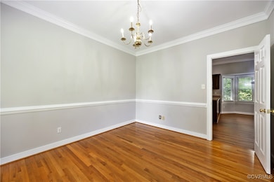 Dining Room has hardwood floors, crown molding and