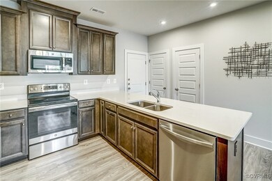 Kitchen featuring kitchen peninsula, sink, stainle