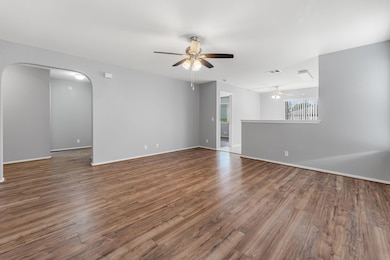 Unfurnished living room with a ceiling fan, arche