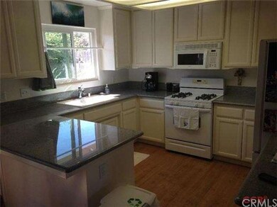 The kitchen features slab granite counter tops, ga