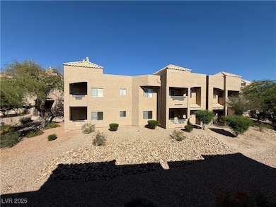 Rear view of house featuring stucco siding, a balcony, and a chimney