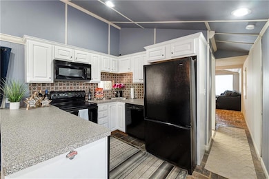 Kitchen featuring tasteful backsplash, white cabin