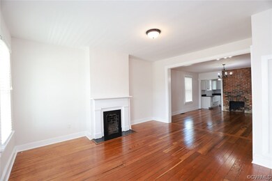 Hardwood floored living room featuring a fireplace
