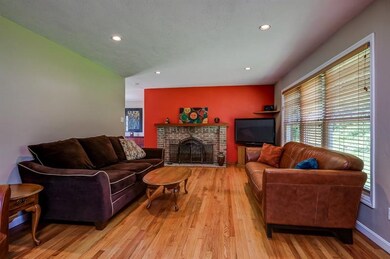 Living room with brick fireplace and large window!
