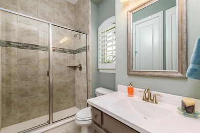 Bathroom featuring walk in shower, toilet, and van
